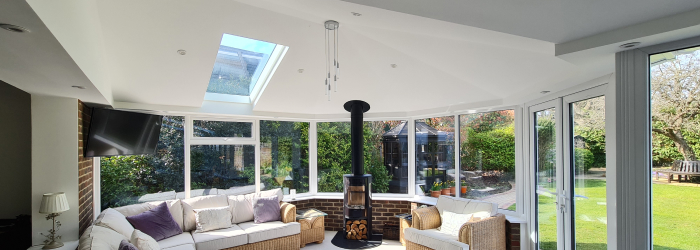 Conservatory with insulated solid roof and large windows for improved energy efficiency