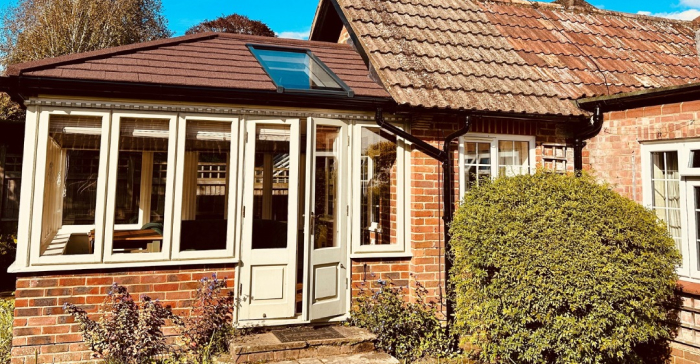 Brick house with SupaLite tiled conservatory roof and skylight in the UK — energy-efficient home improvement providing year-round comfort.