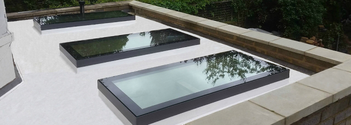 Flat roof with three sleek SupaLite flat rooflights providing natural light and a contemporary finish — ideal for modern home extensions.