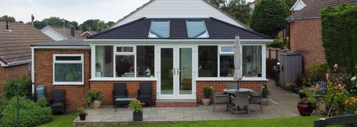 Brick bungalow with a SupaLite tiled conservatory roof and skylights, transforming a traditional extension into a bright, energy-efficient living space.