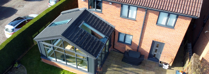  Detached house with a tiled conservatory roof replacement and glazed conservatory structure