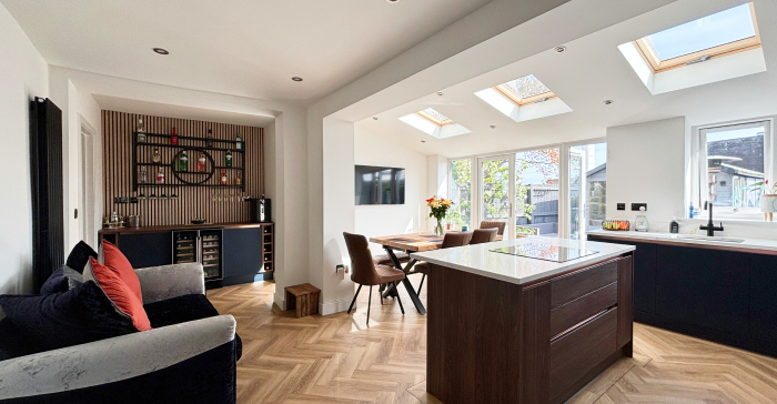 Modern home extension with large sliding glass doors and open-plan kitchen living area